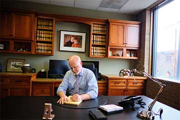 Steven Hill working at his desk